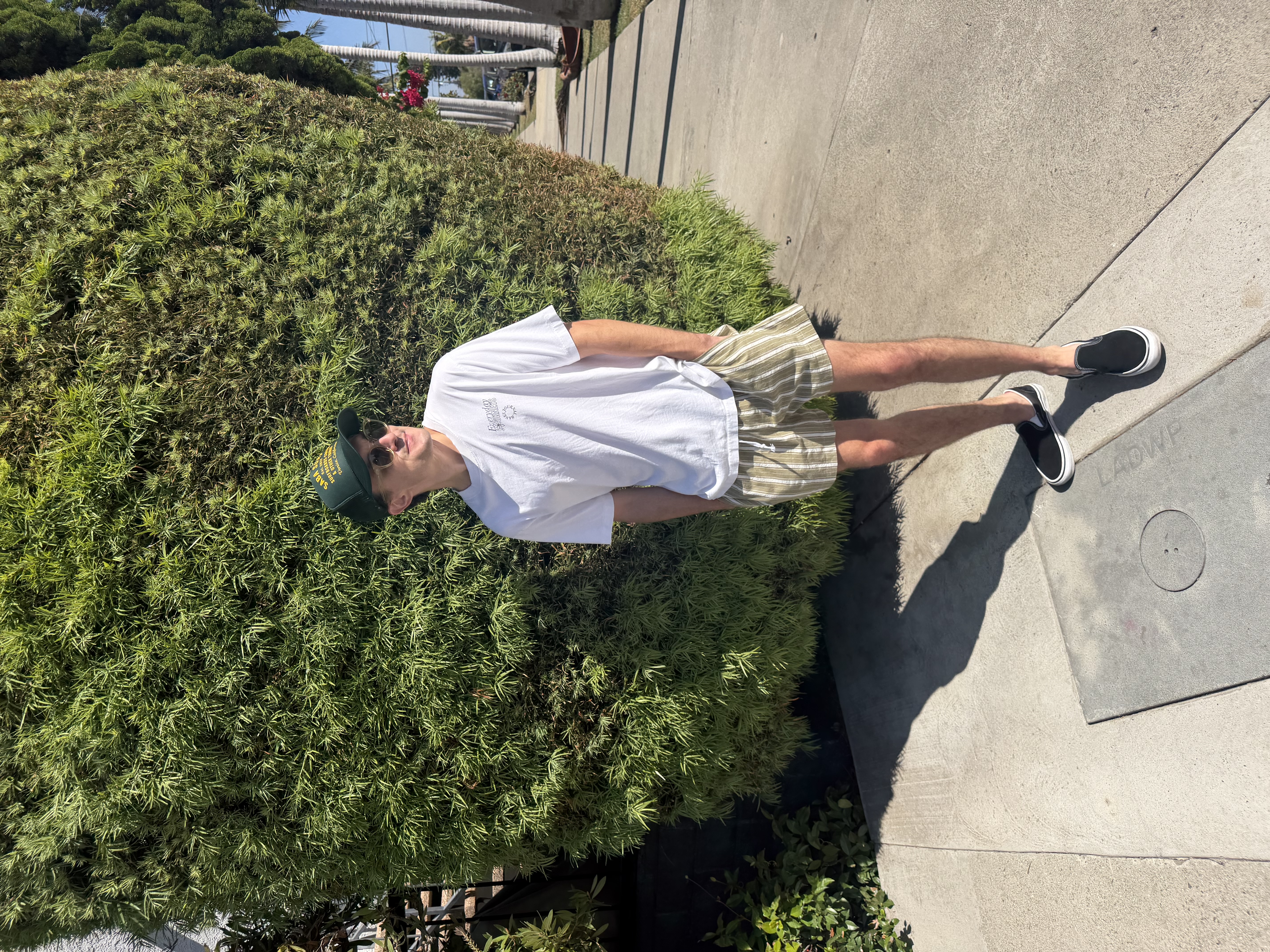 Chris standing outside wearing the finished white and green striped pull-on shorts